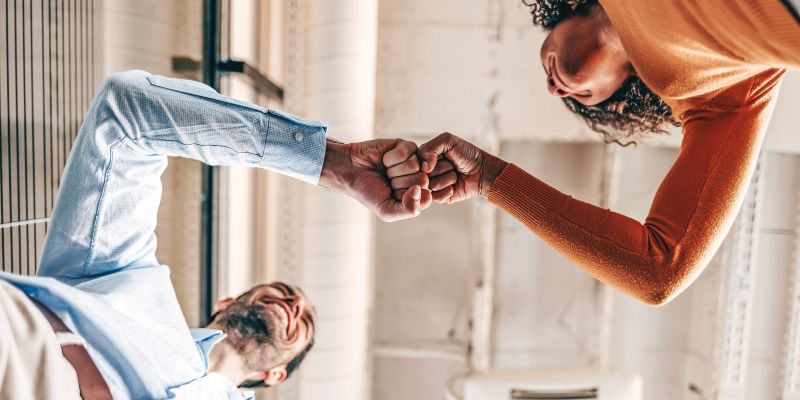 Image shows colleagues celebrating. To illustrate U Ethical' milestone in community contributions.